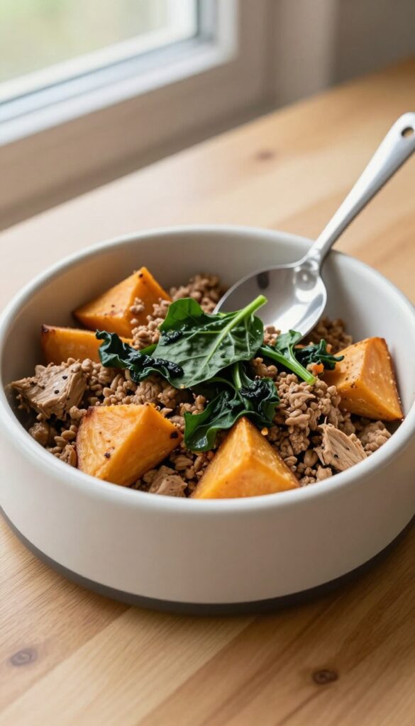 Homemade dog food meal prep bowl with turkey, sweet potato, and spinach in a dog bowl on a wooden table