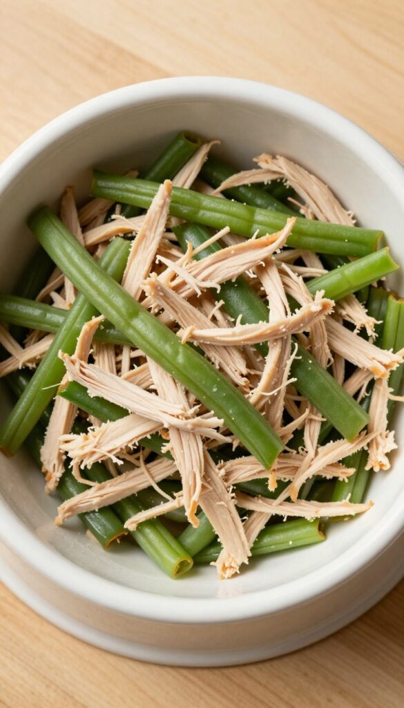 Homemade dog meal of shredded chicken and green beans in a bowl