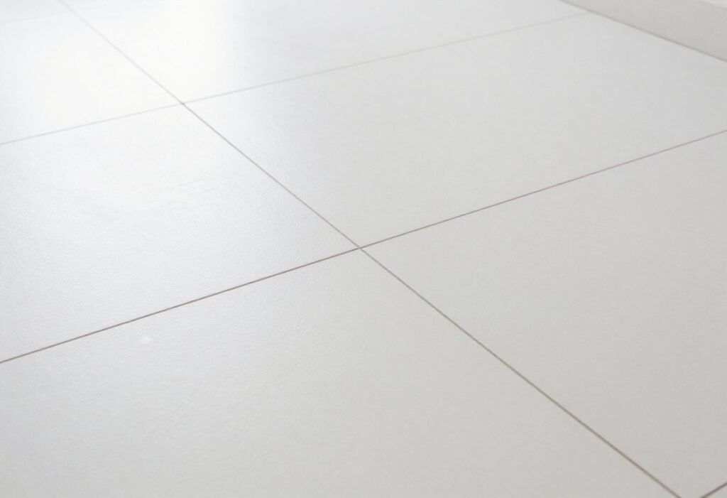 Clean white tile floor with bright grout lines